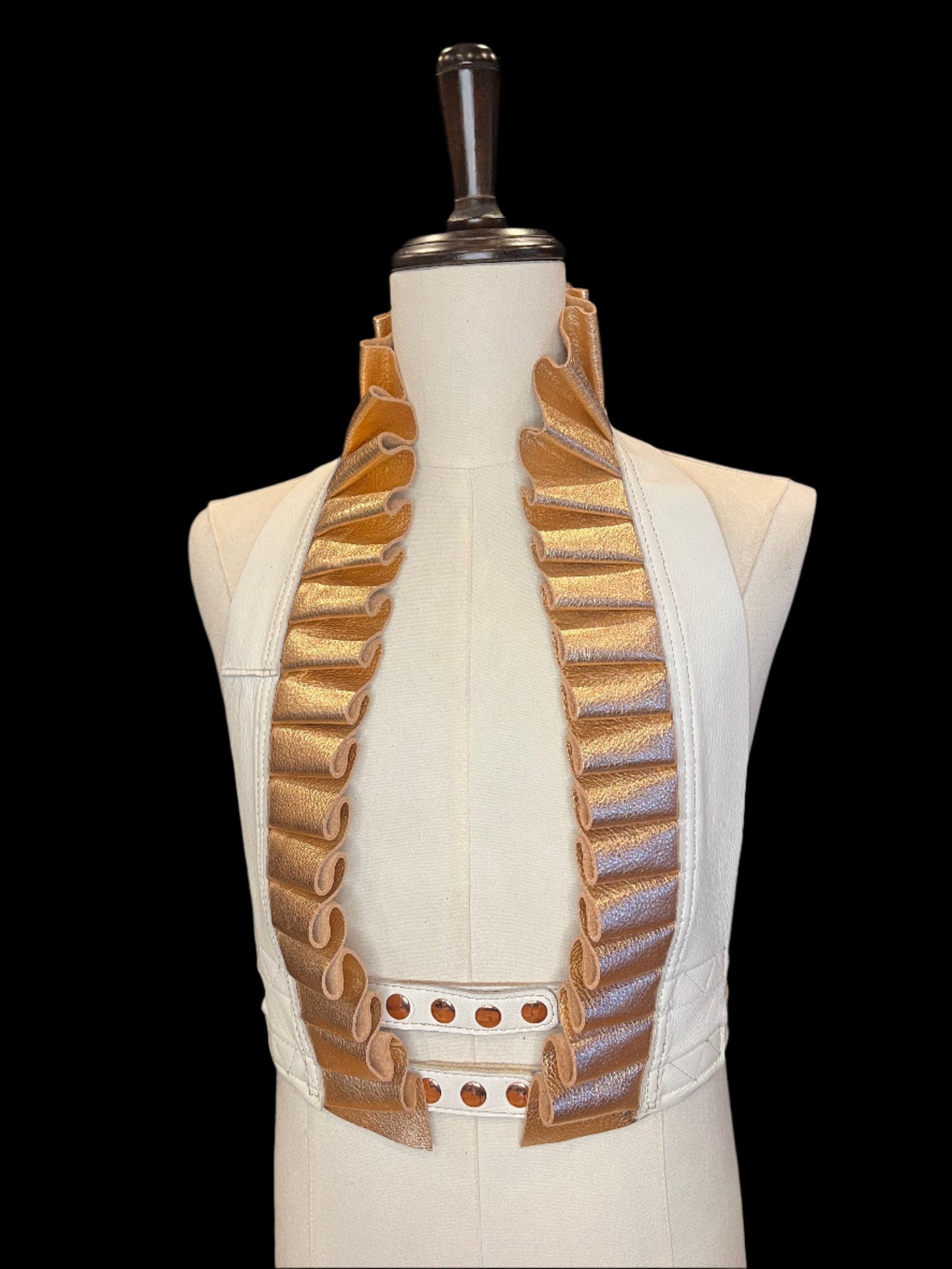 Angelus Ruff top in white and rose gold leathers on an ivory gender neutral mannequin against a black background