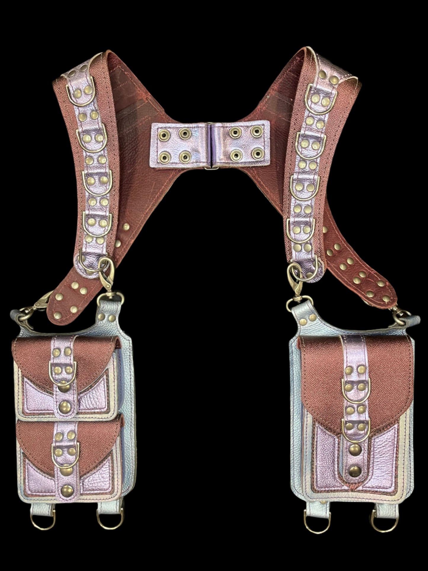 Belladonna Holster in maroon and lilac leathers laid flat on a black background