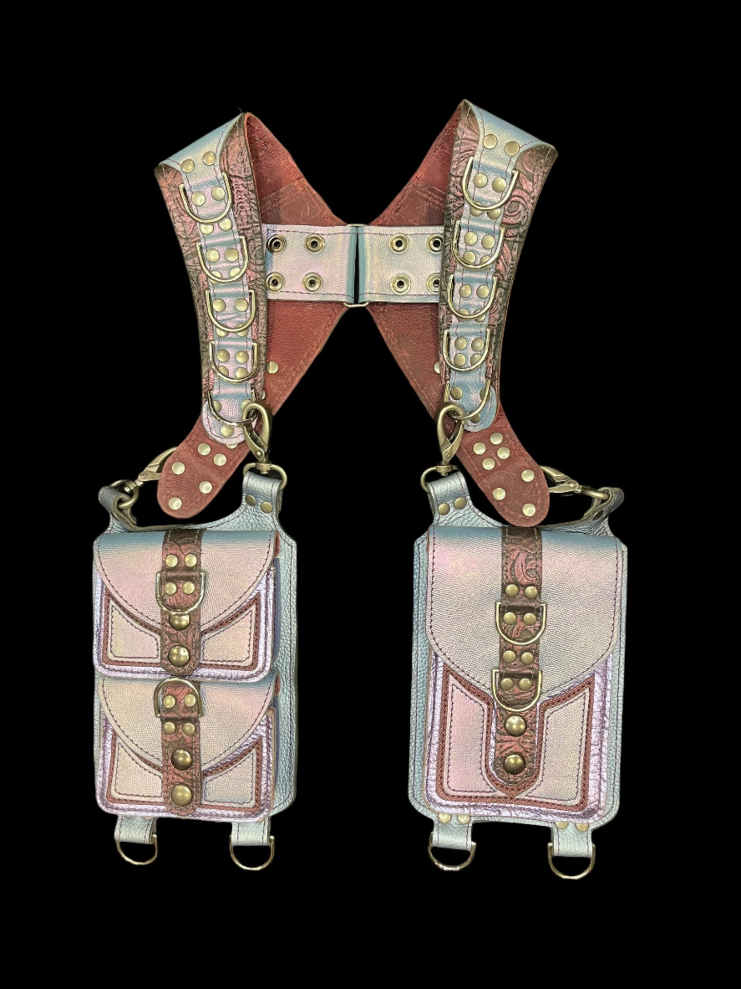 Belladonna holster in lilac and maroon leathers with nickel hardware laid flat on a black background