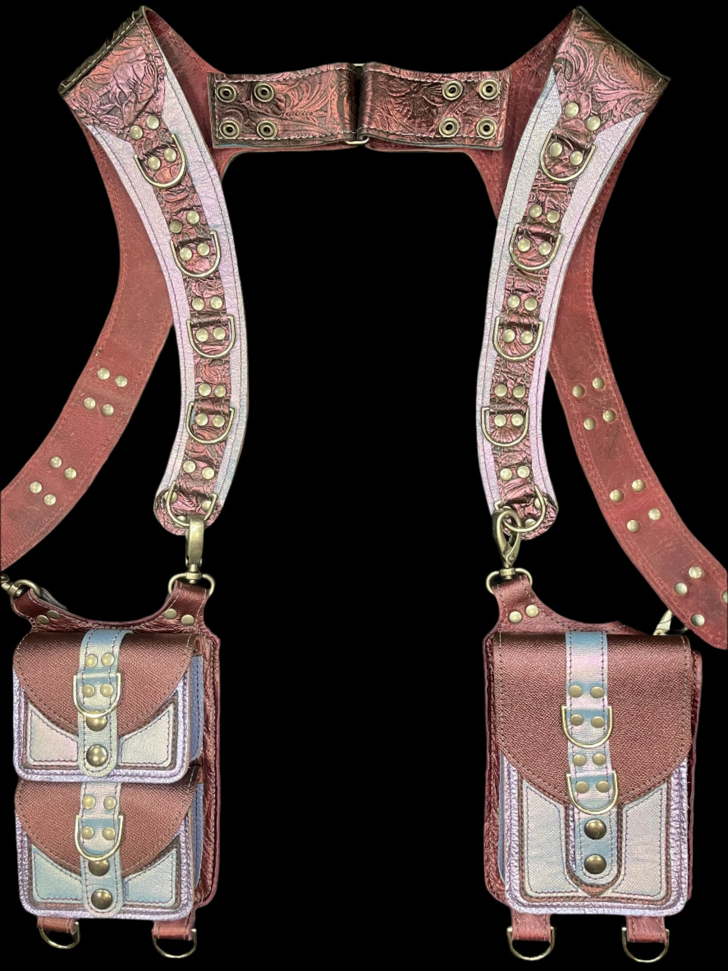 Belladonna holster in maroon and lilac leather with pewter hardware laid flat on a black background