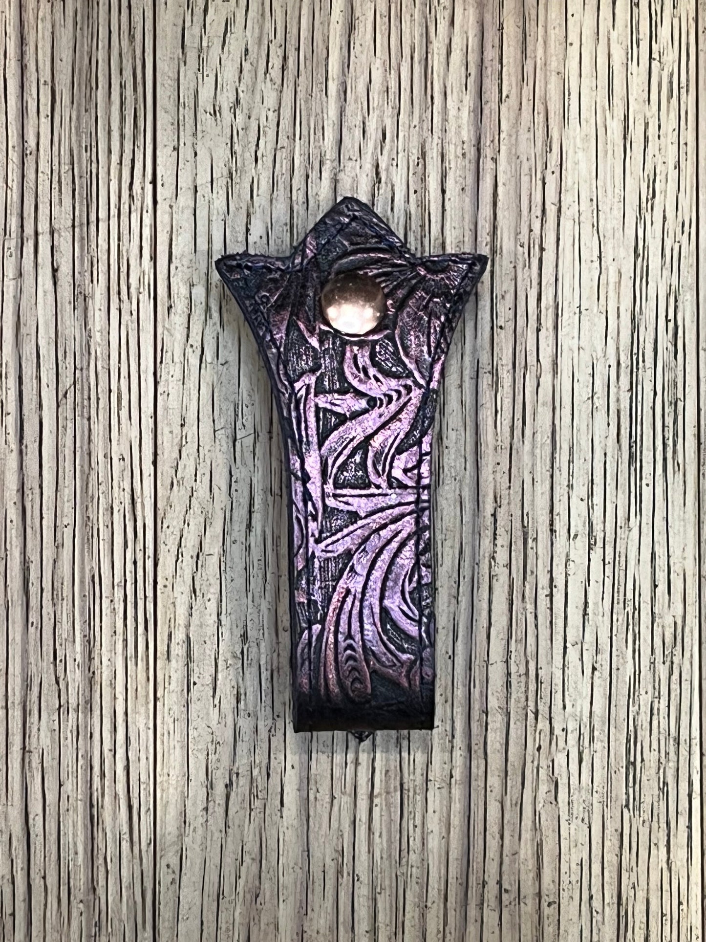 A trident shaped double layered mug frog using purple floral leather, black stitching and a rose gold snap.