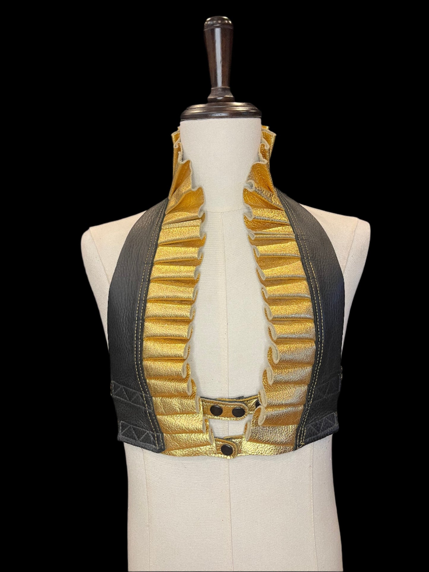 Gold and black leather ruff top on ivory gender neutral mannequin against a black background