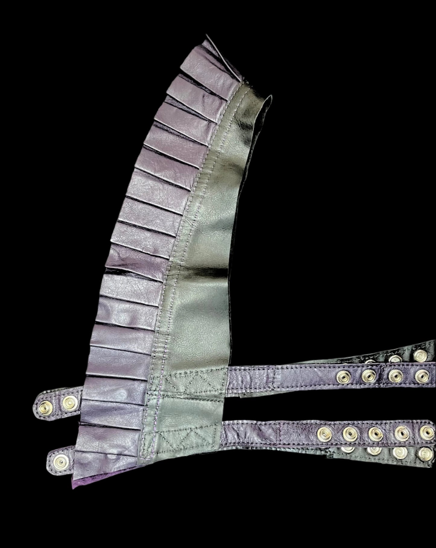 black and dark plum leather ruff top laid flat on it's side on black background