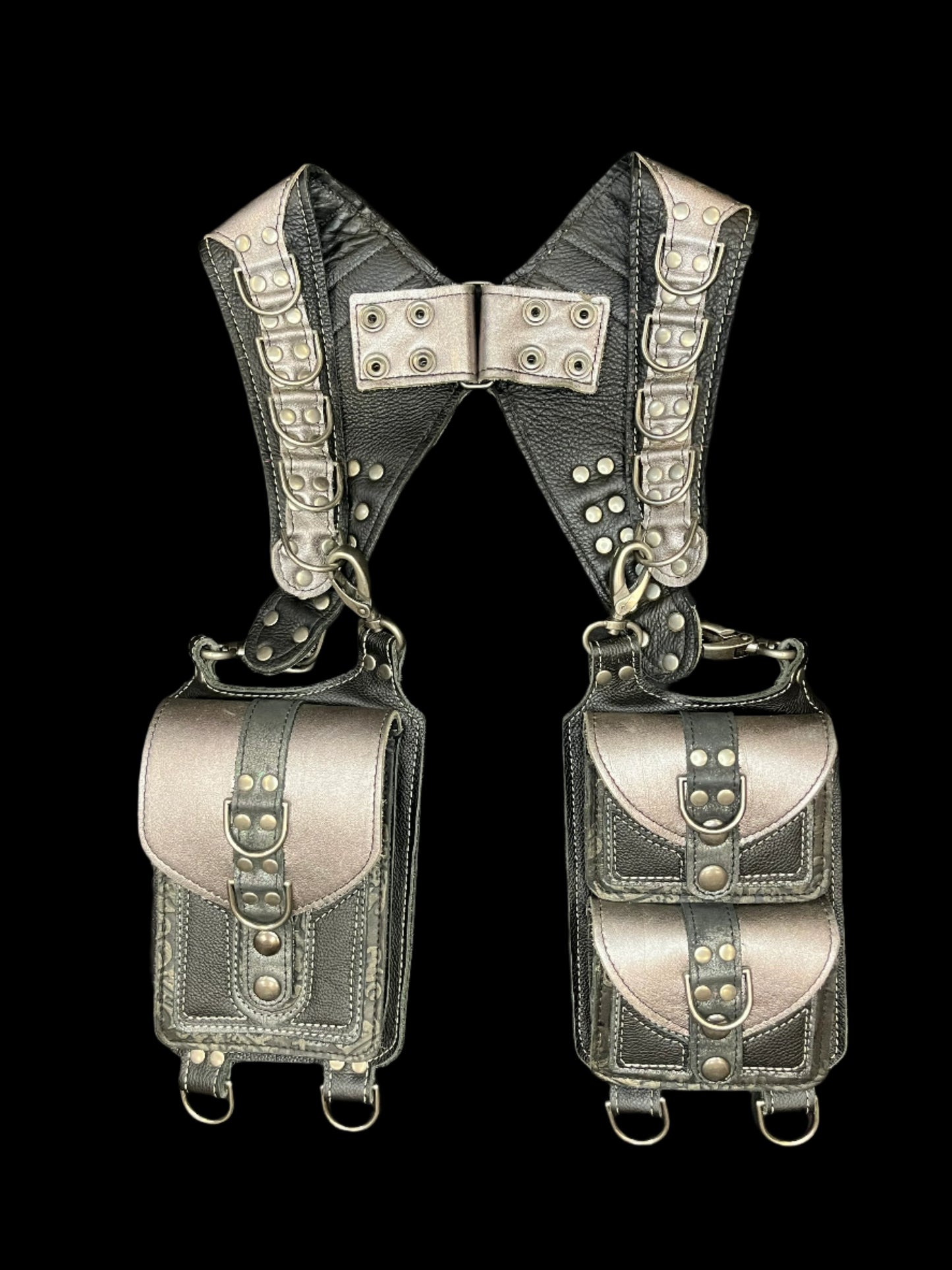 Izzy holster in black and silver laid flat on a black background