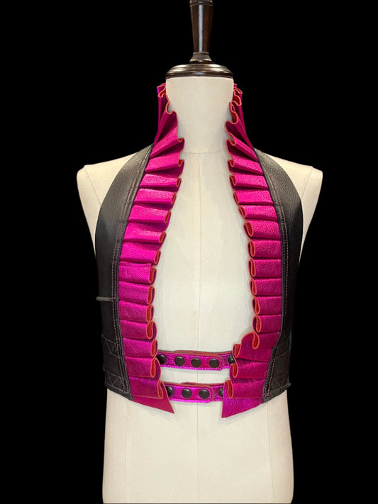 Black and metallic magenta leather ruff top with black hardware on an ivory non-gendered mannequin against a black background