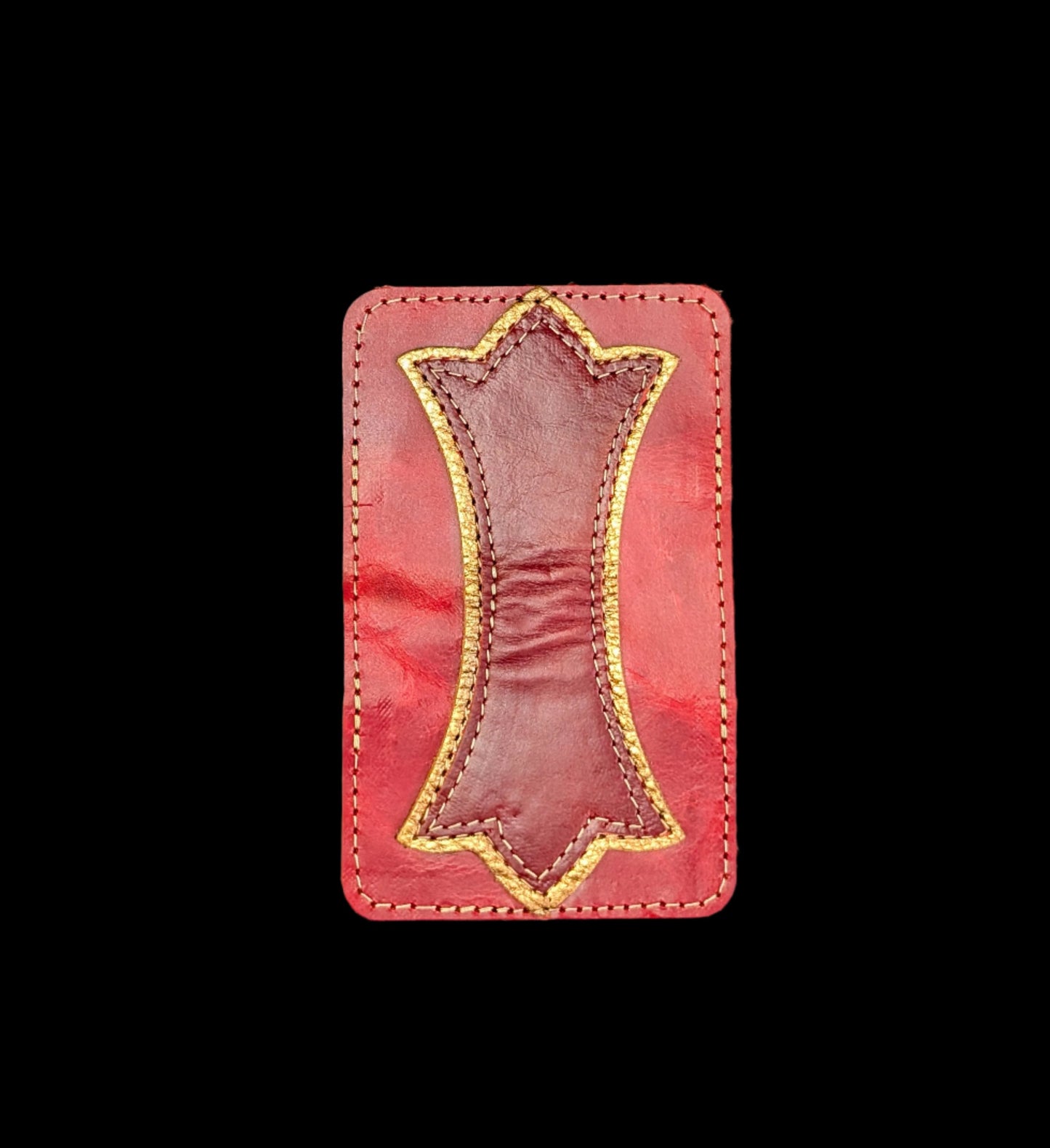 A photo of the outside of a wallet laid flat showing a base color of red leather with a layered trident accent of bronze leather and red leather and red and bronze stitching.