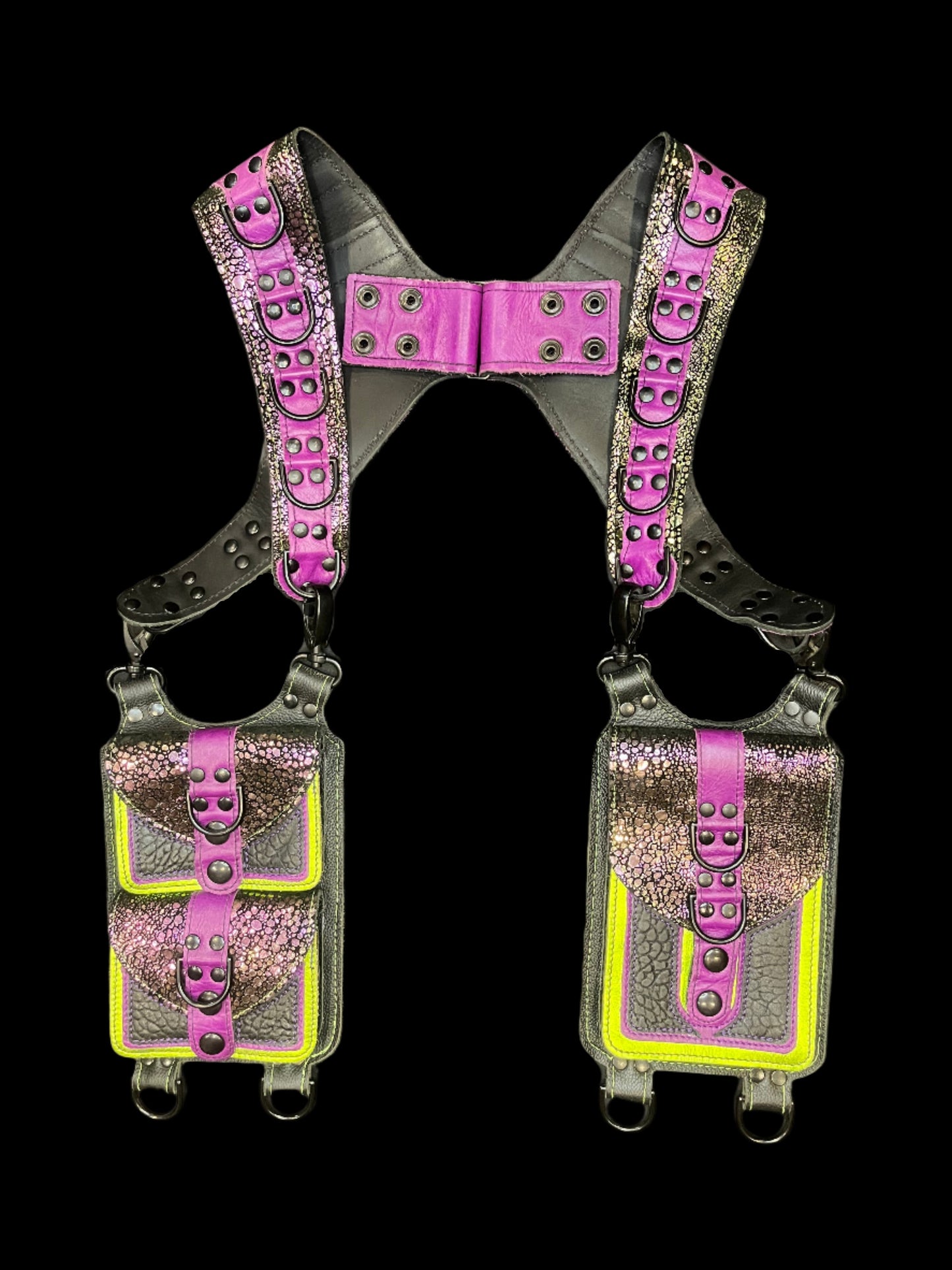Uninvited Guest holster in purple, lime green, dragonscalale, and black leathers laid flat on a black background