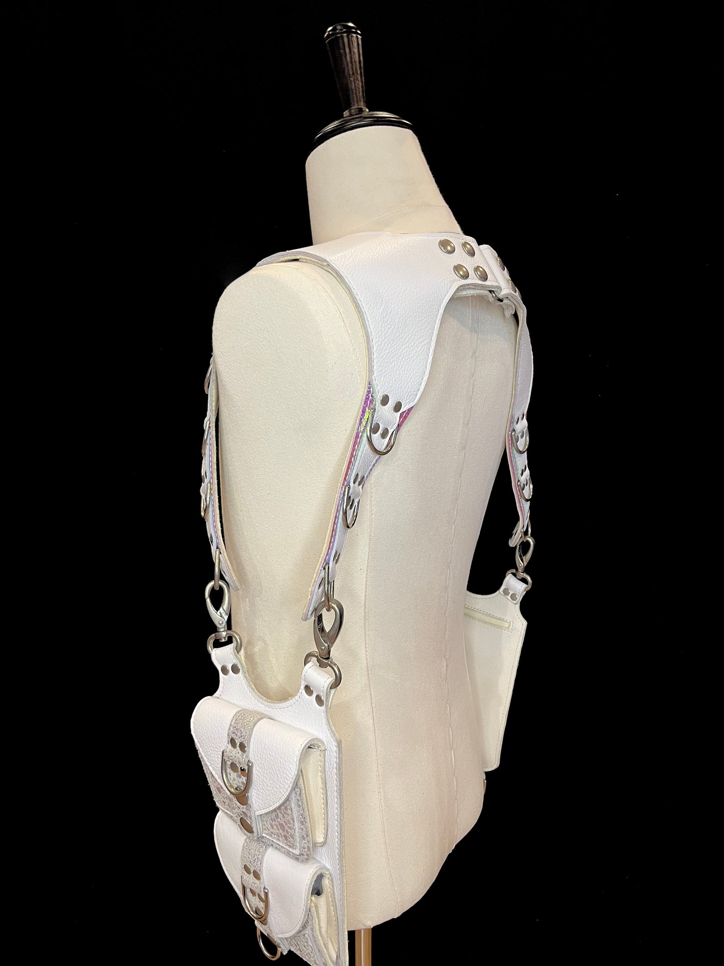 side view of falcor holster on an ivory gender neutral mannequin against a black background
