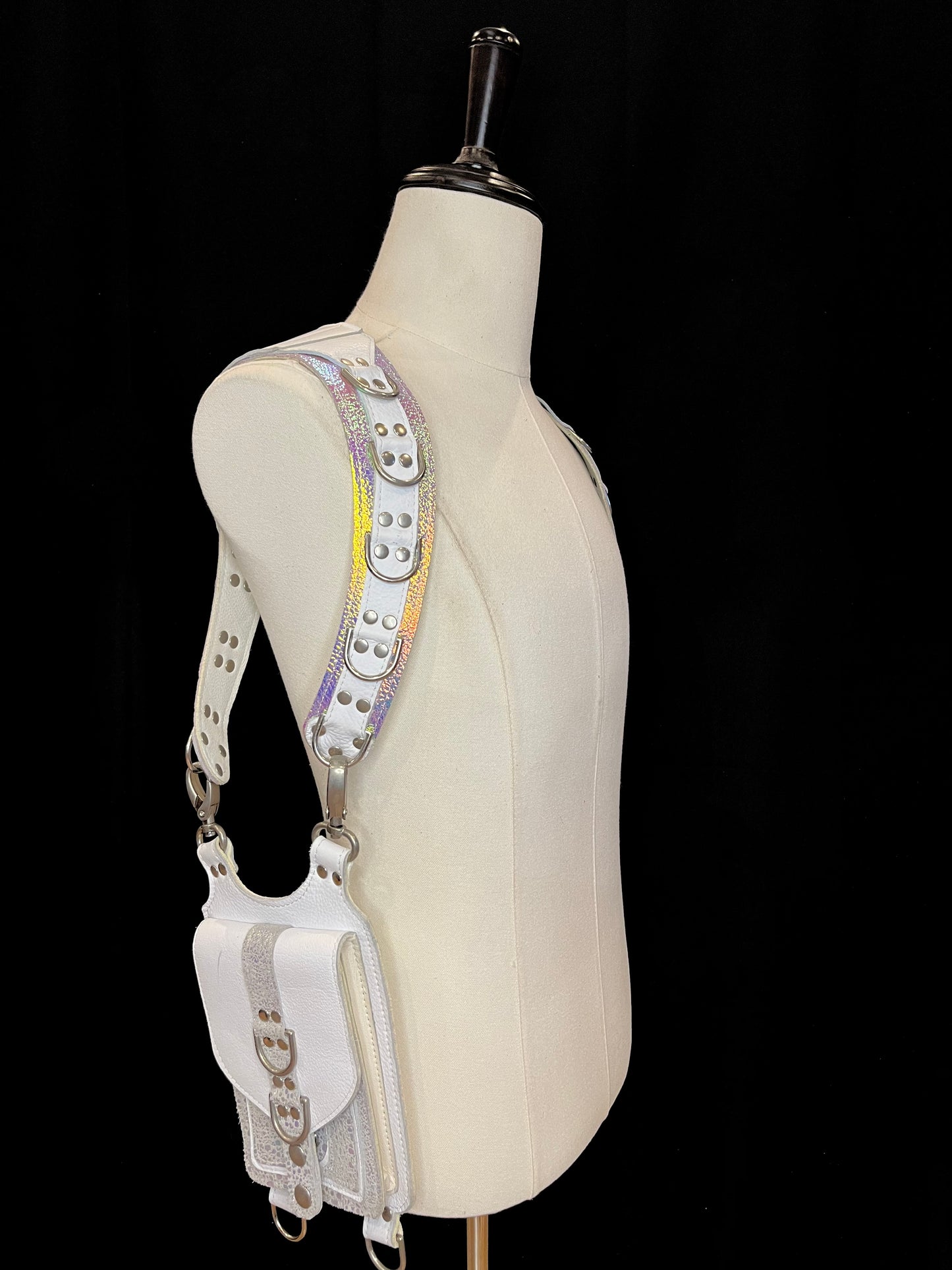 side view of falcor holster on an ivory gender neutral mannequin against a black background