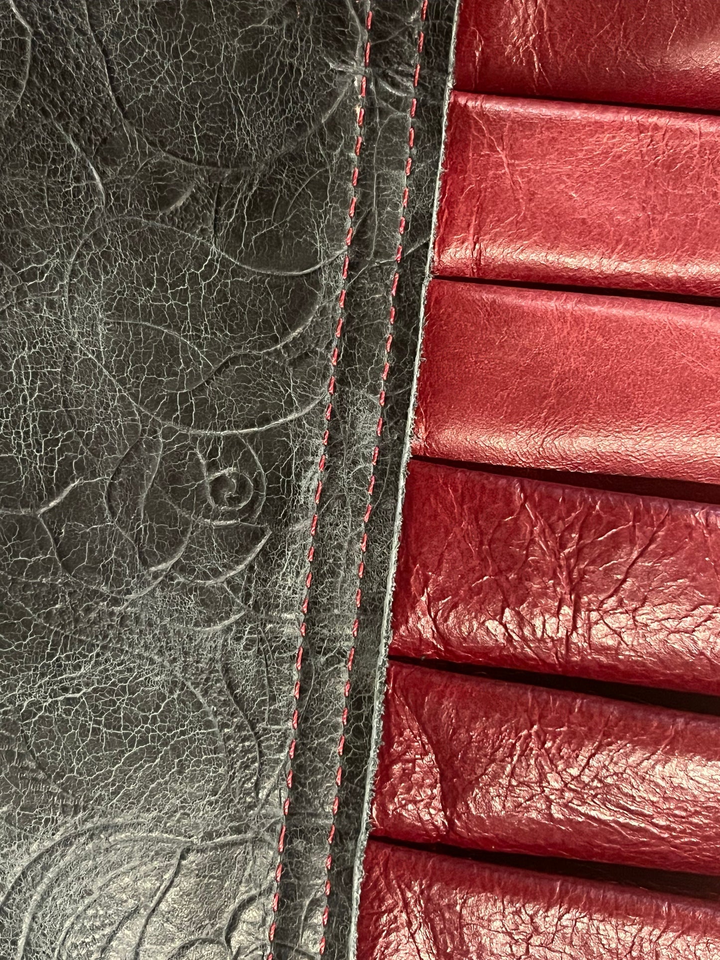 close up view of Miss Scarlett ruff top showing the tooled roses black leather neck and cabernet leather ruff and red stitching