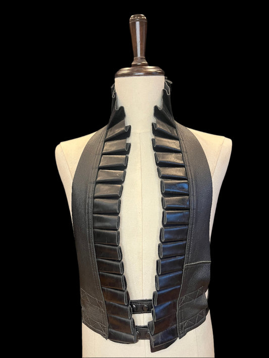 Black leather ruff on an ivory mannequin against a black background 