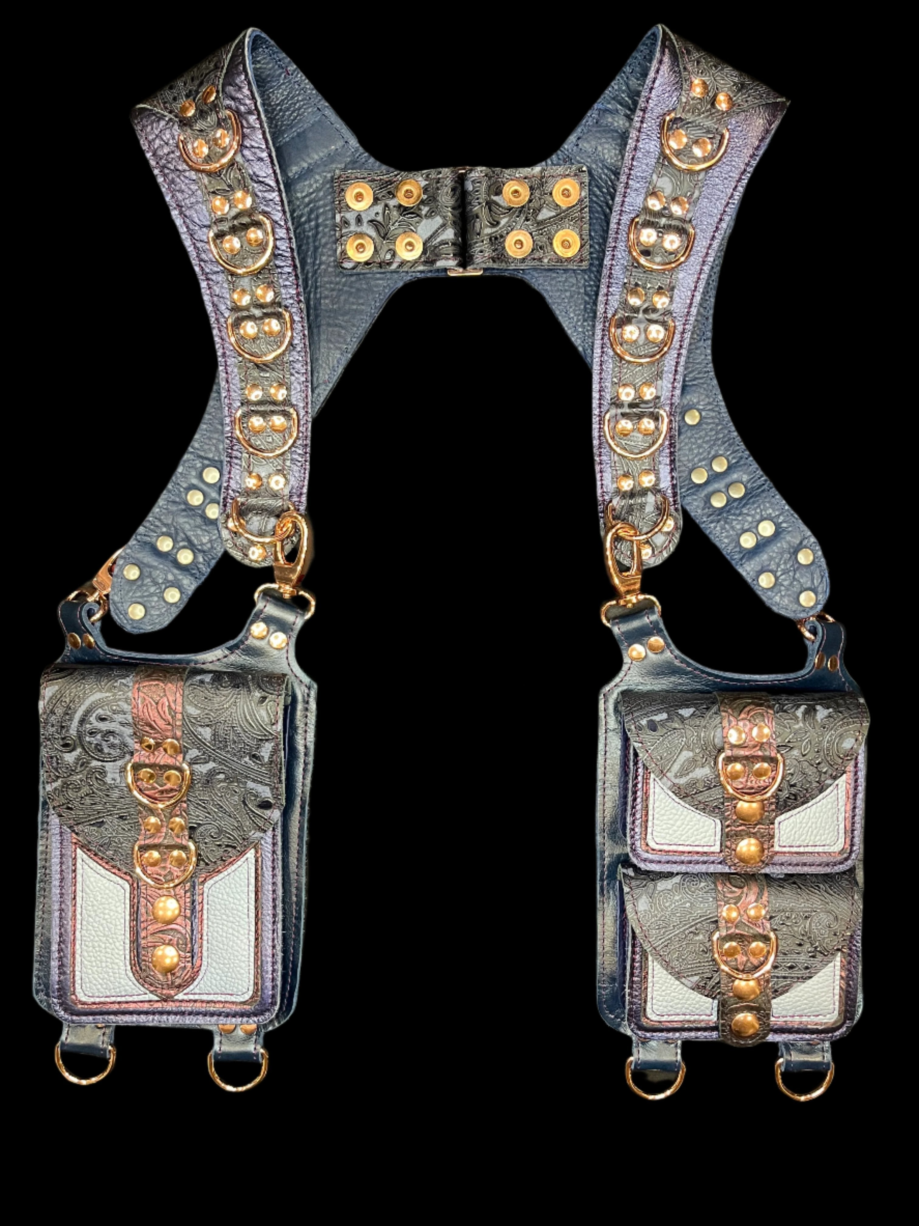 Cordelia holster in blue and maroon leathers laid flat on a black background 