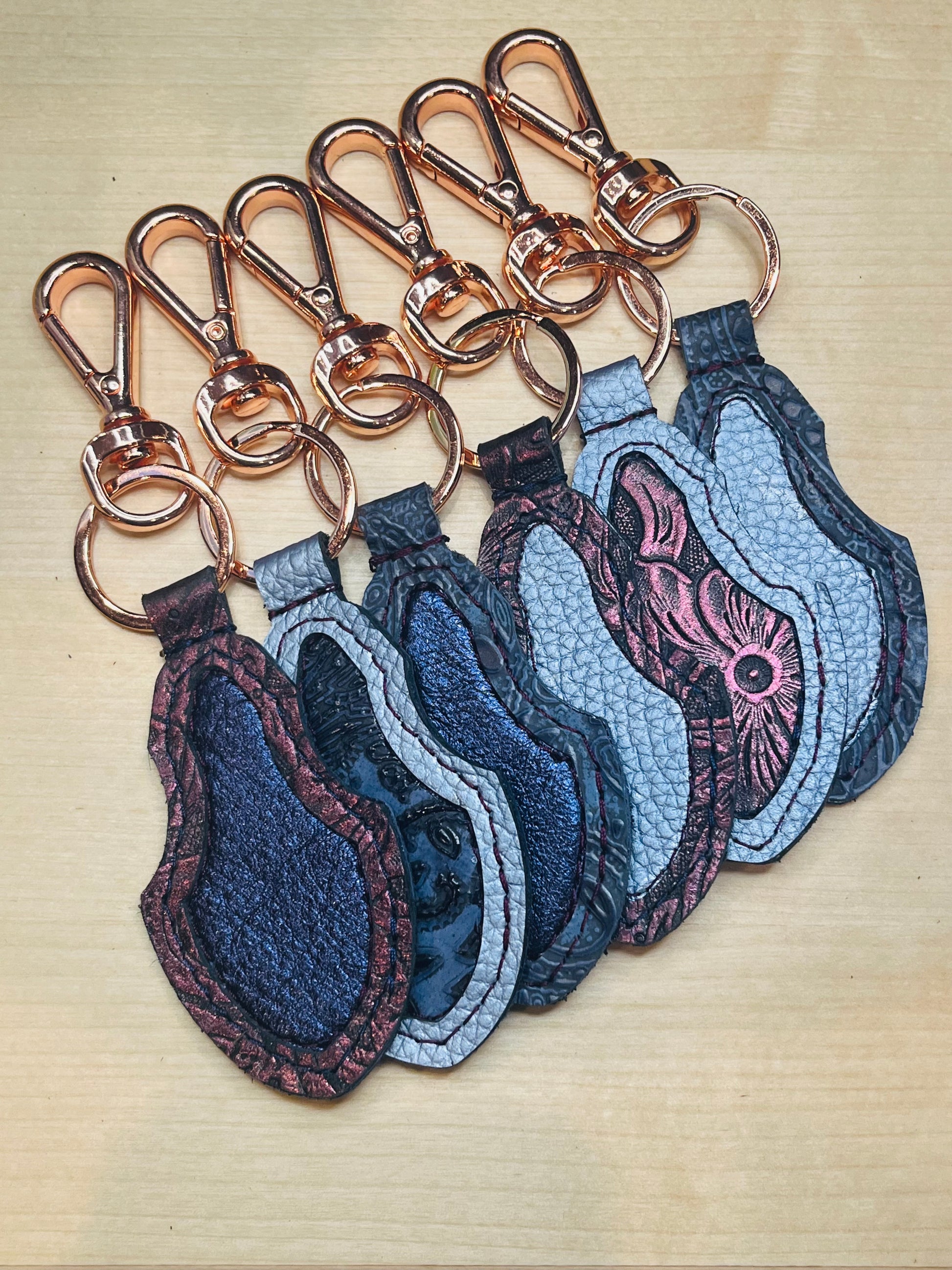 Lineup of 6 key chains in Cordelia colorway with rose gold hardware