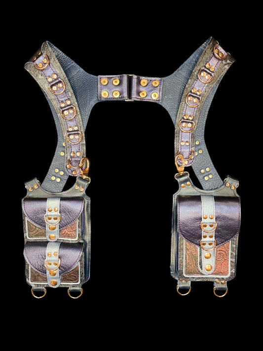 Cordelia holster in blue and maroon leathers laid flat on a black background