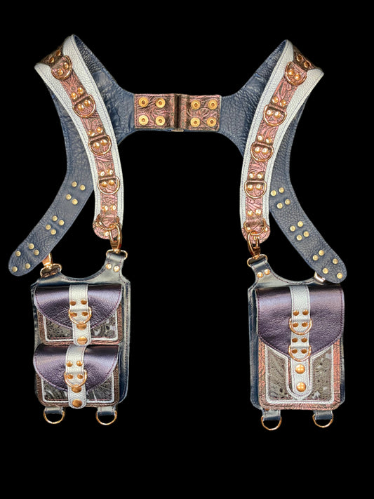 Cordelia holster in blue and maroon leather laid flat on a black background