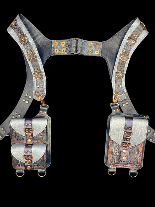 Cordelia holster in blue and maroon leathers laid flat on a black background