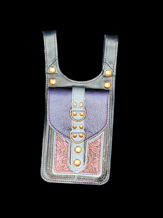 Cordelia thigh bag in blue and maroon leather with rose gold hardware on a black background