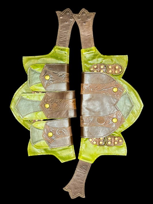 Fiddlehead belt without sizing pieces laid flat on black background