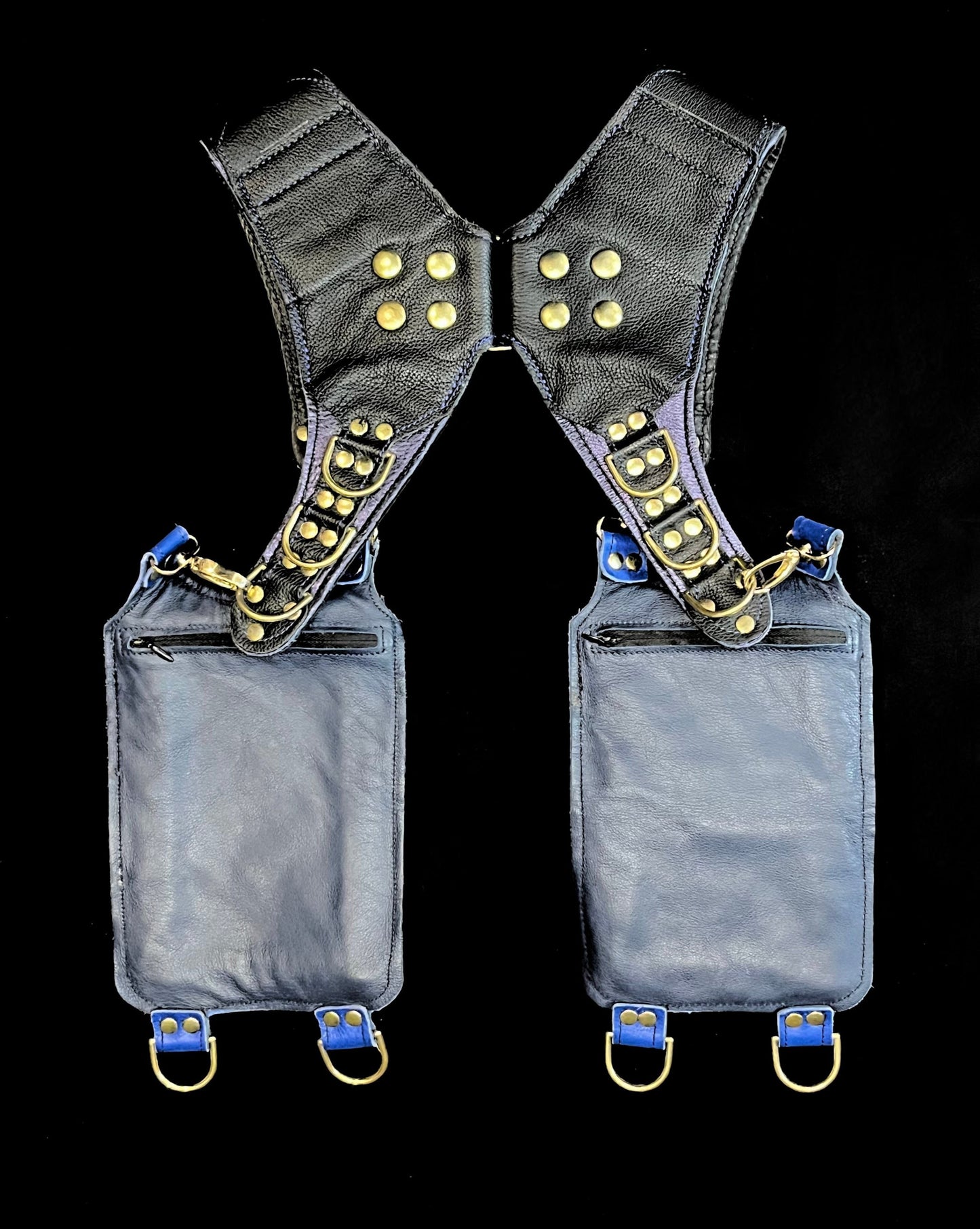 back view of black and blue leather hoslter showing hidden zipper pockets on hanging pockets