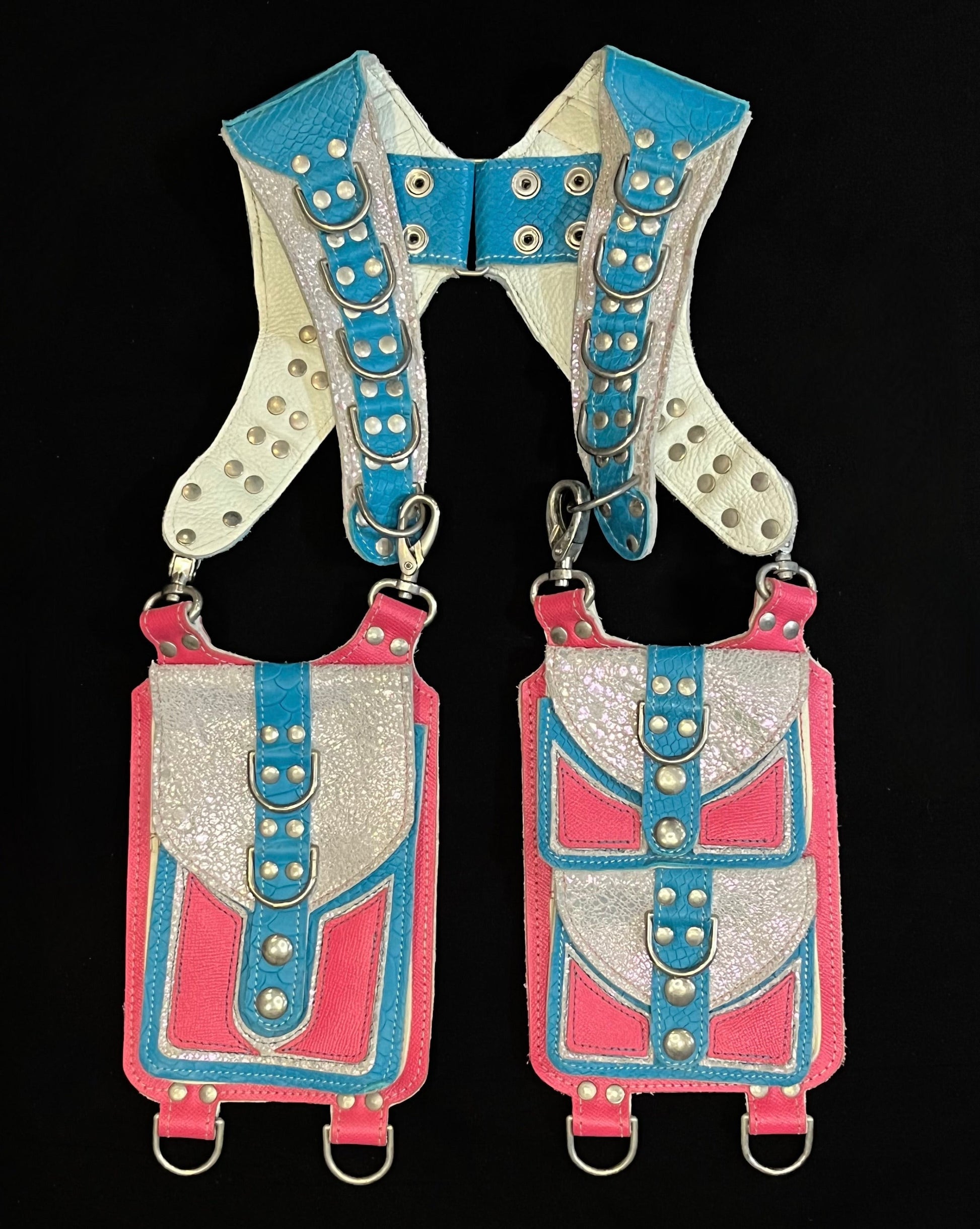 front view of turquoise and pink leather holster with hanging pockets and nickel hardware