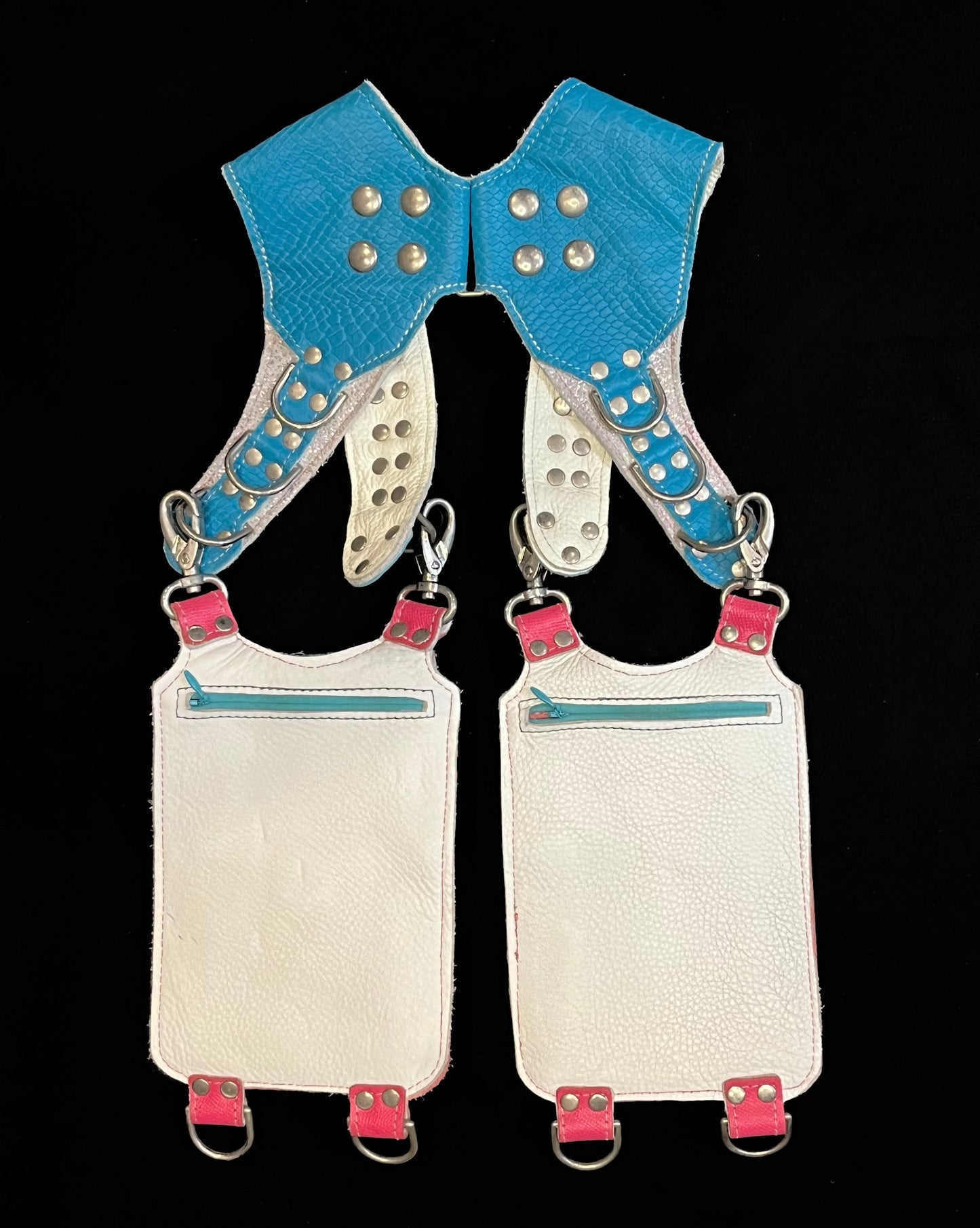 back view of pink and turquoise holster showing hidden zipper pockets on hanging pockets