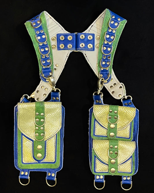 Front view of green and blue leather holster with hanging pocket and brass hardware