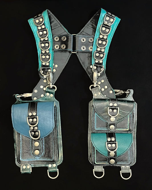 front view of black and mismatched teal and blue leather holster with hanging pockets and nickel hardware