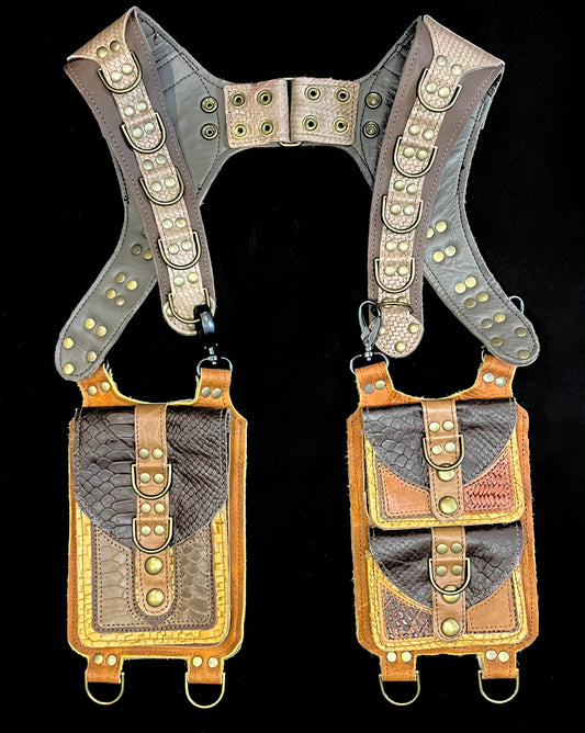 front view of mismatched brown, taupe, and ochre leather holster with hanging pockets and antique brass hardware
