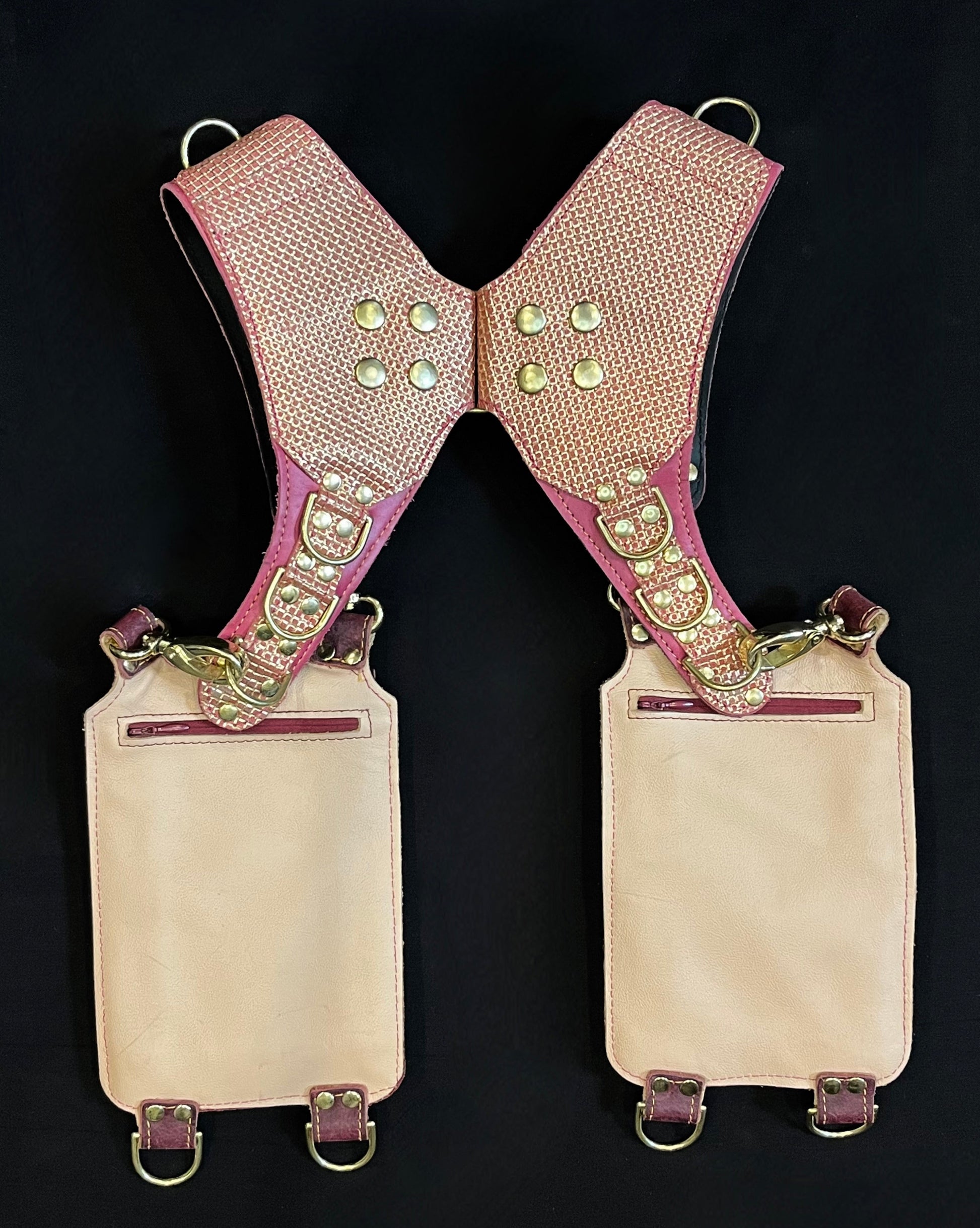 back view of pink and plum leather holster showing hidden zipper pockets on hanging pockets