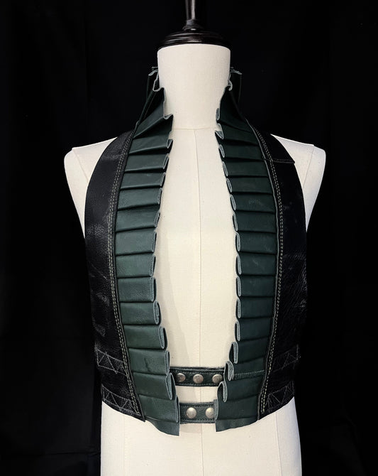 black and forest green leather ruff top with nickel hardware on a ivory gender neutral mannequin against a black background