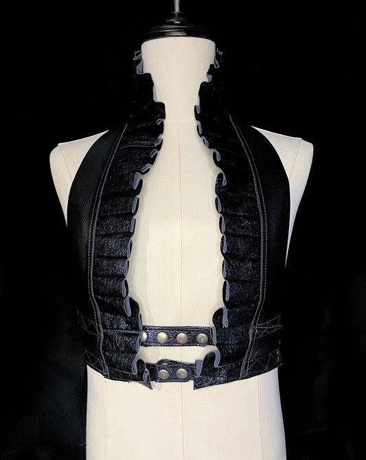 Black and sapphire crinkle leather ruff top with nickel hardware on an ivory gender neutral mannequin against a black background