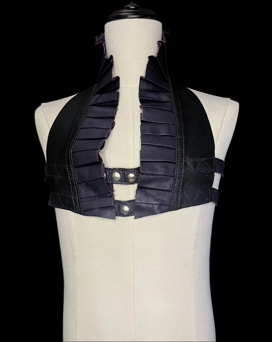 black and dark plum leather ruff top with nickel hardware on a ivory non-gender mannequin against a black background