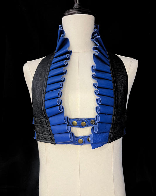 black and royal blue leather ruff top with antique brass hardware on an ivory gender neutral mannequin against a black background