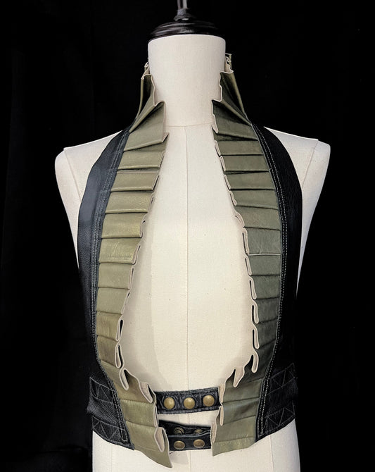 antique gold and black leather ruff top with antique brass hardware on an ivory gender neutral mannequin against a black background