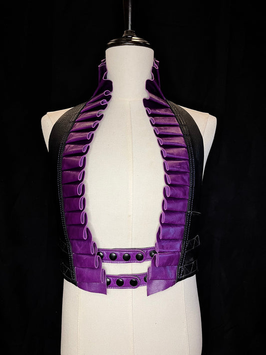 Amethyst purple leather ruff with a black leather neck and black hardware on a ivory non-gender mannequin against a black background