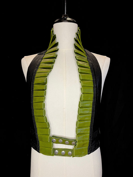 Apple green leather ruff with a black leather neck with nickel hardware on a ivory non-gender mannequin against a black background