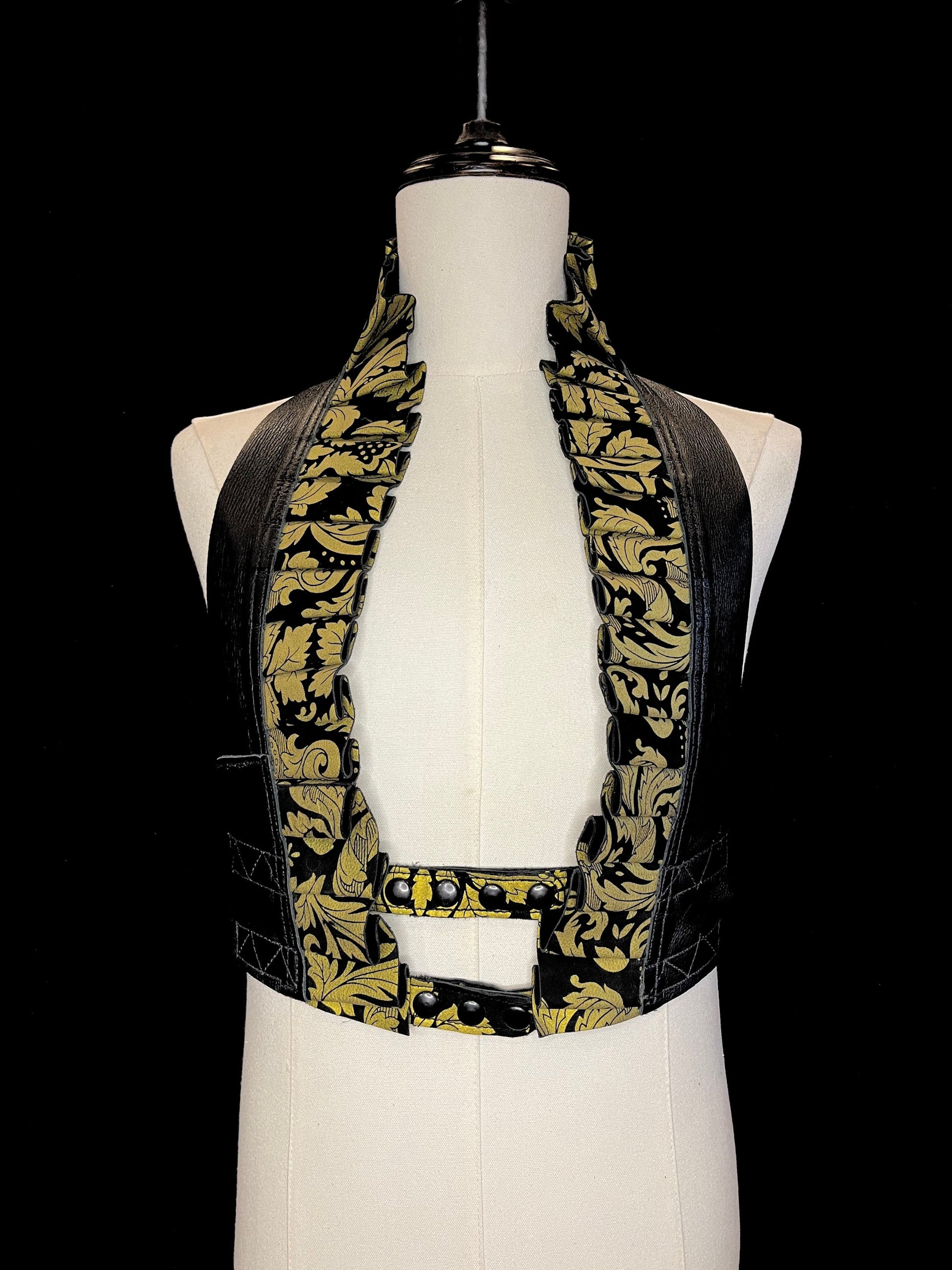 Black and Gold Damask printed leather ruff with a black leather neck and black hardware on a ivory non-gender mannequin against a black background