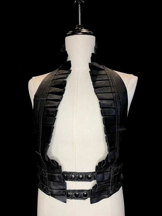 black leather ruff with matching black leather neck and black hardware on a ivory non-gender mannequin against a black background