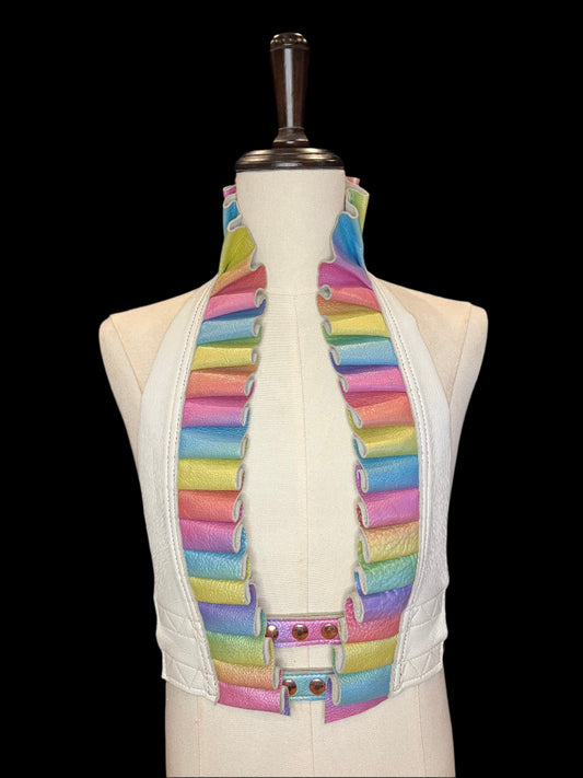 Opaline ruff top with white leather neck and pastel rainbow leather ruff on an ivory mannequin against a black background