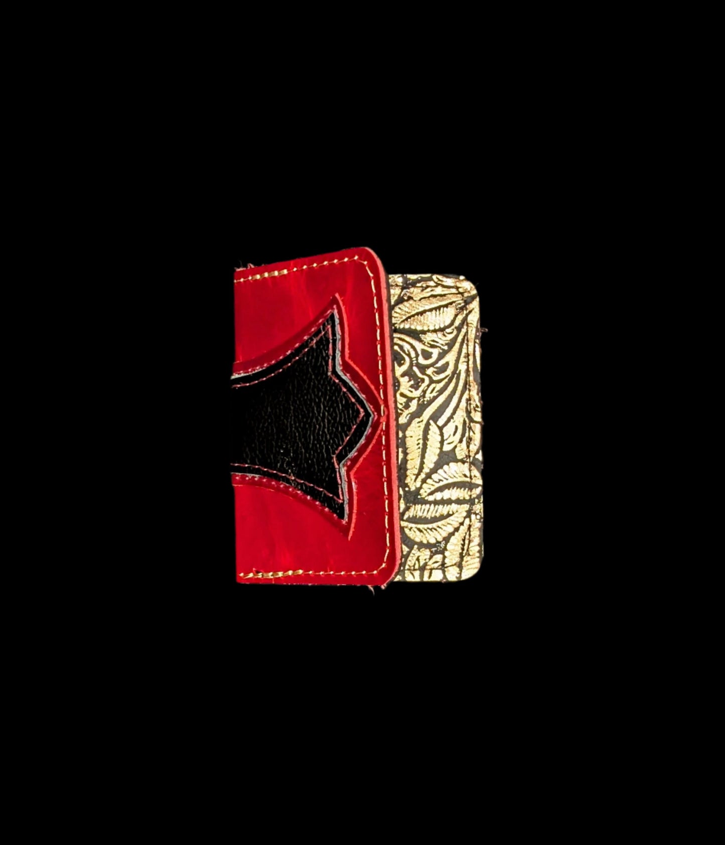 A wallet folded in half showing a base color of red leather with a layered trident accent in red and black leather with red and bronze stitching.