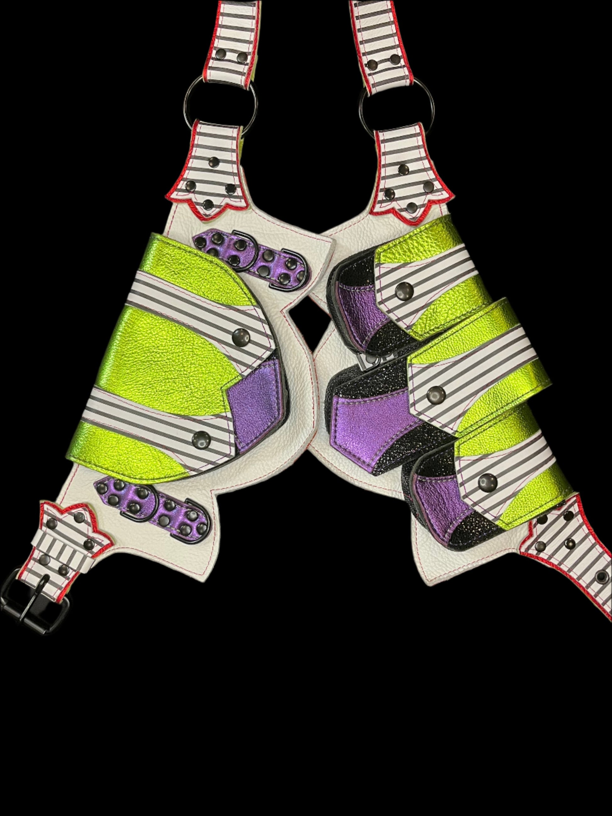 Leather regal belt laid flat showing black and white striped, metallic lime, metallic purple, and metallic red leather and black hardware on a black background