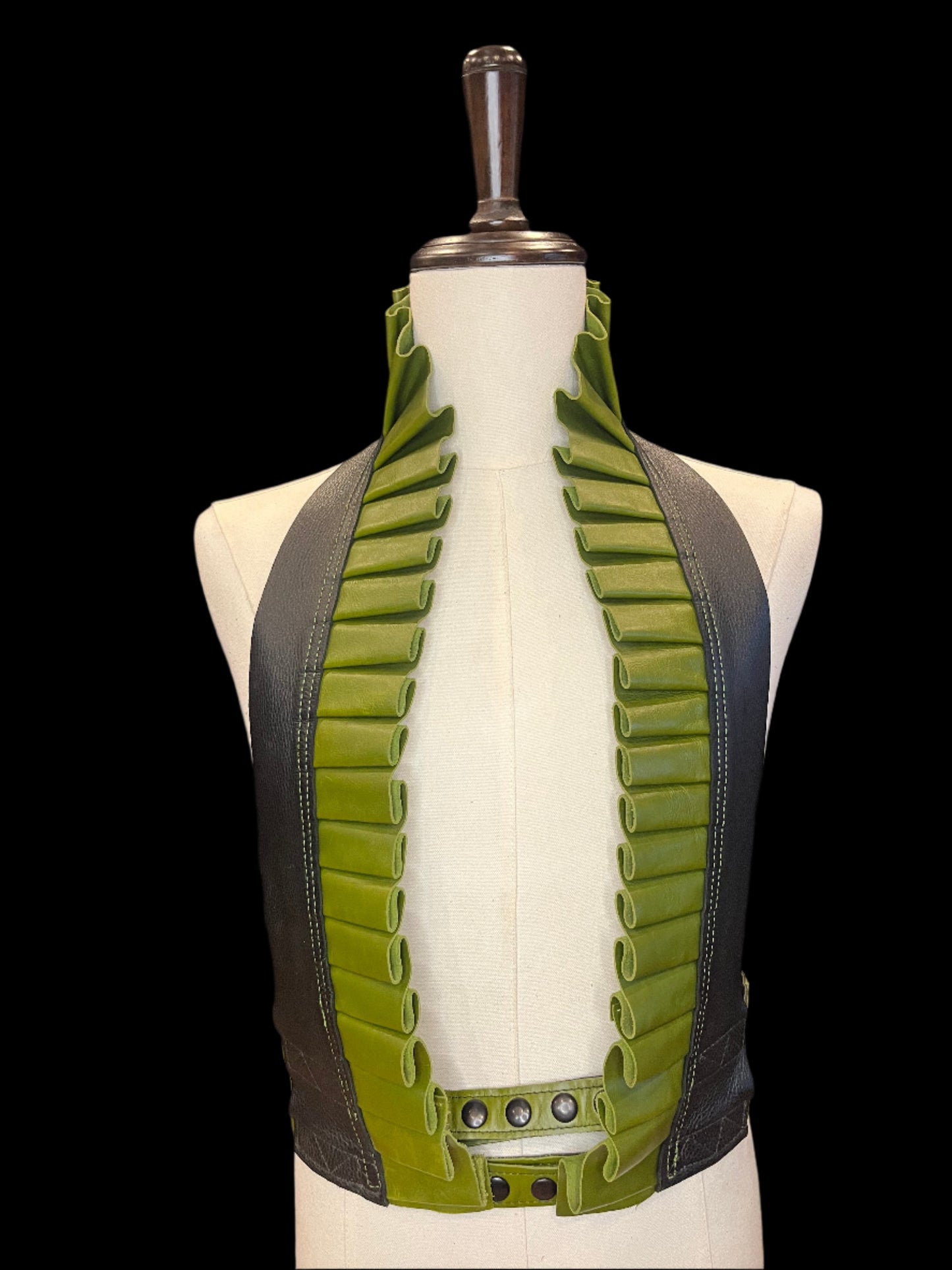 Black and apple green leather ruff top on an ivory mannequin against a black background