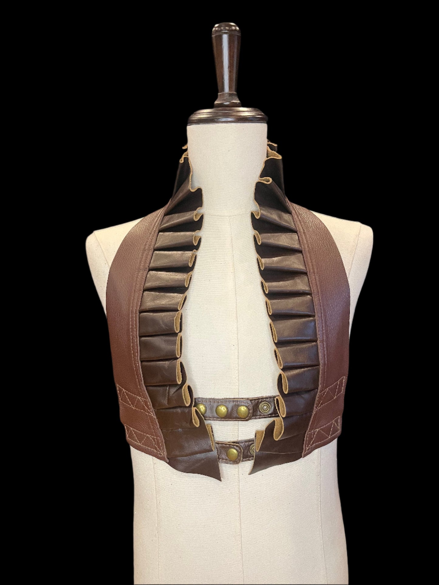 Brown on brown leather ruff top on an ivory mannequin against a black background