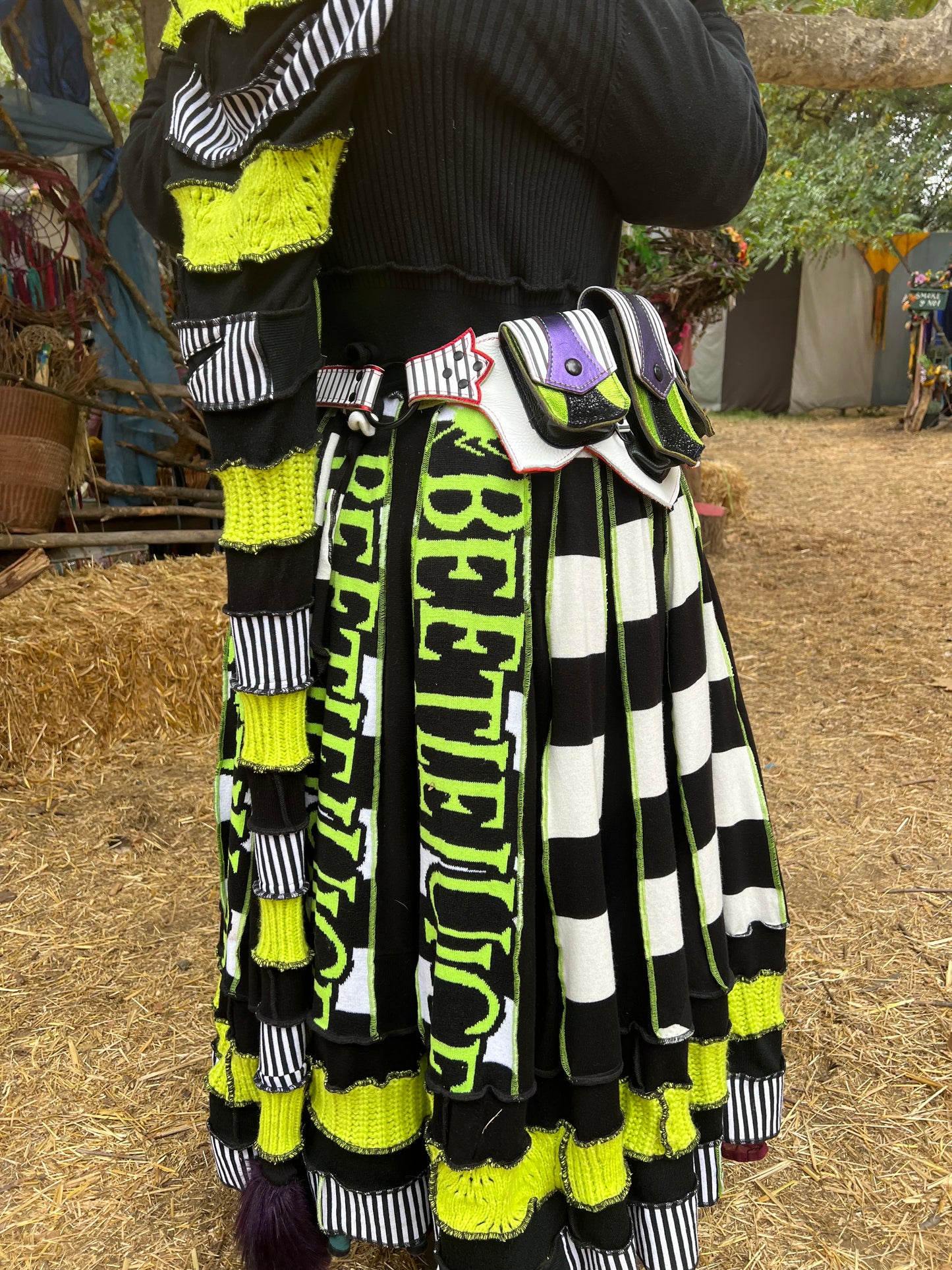 Showing the Showtime!! beetlejuice inspired leather regal belt on a body wearing a matching long beetlejuice themed sweater/robe by Pandora's Kloset. 