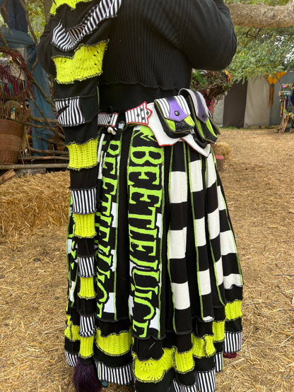 Showing the Showtime!! beetlejuice inspired leather regal belt on a body wearing a matching long beetlejuice themed sweater/robe by Pandora's Kloset. 