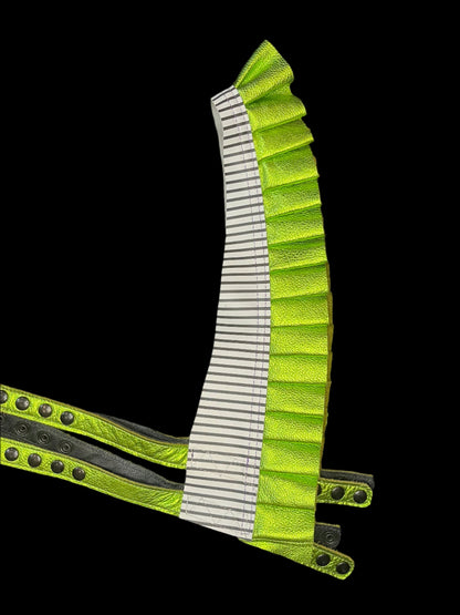 Showtime!! Ruff Top laid flat on a black background showing black and white striped leather neck and metallic lime green ruff leather with black hardware on the snap straps. 